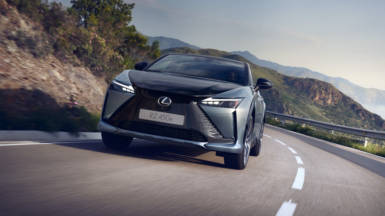 Front view of a Lexus RZ 450e driving in a mountainous location 