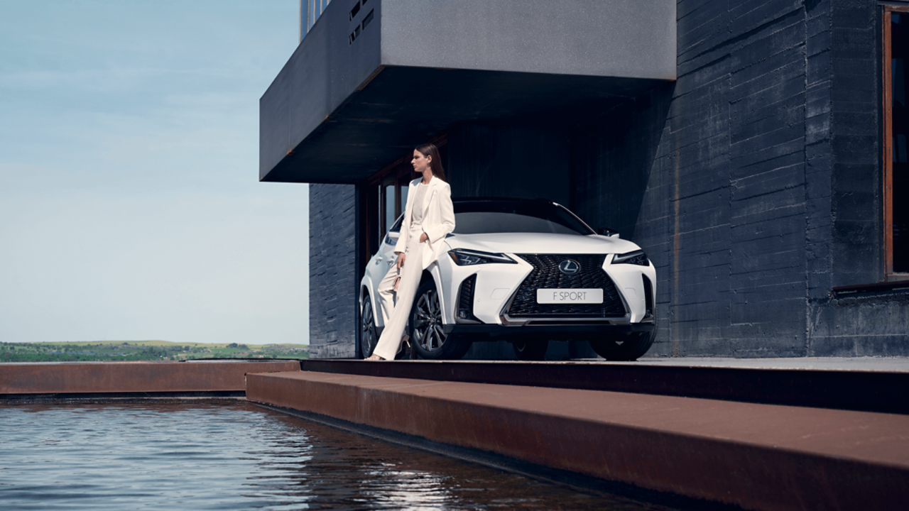 Човек, облегнат на Lexus UX