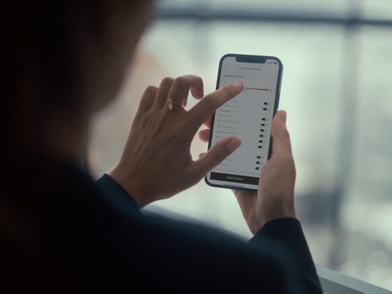 A person using a mobile phone to access the Lexus Link+ app